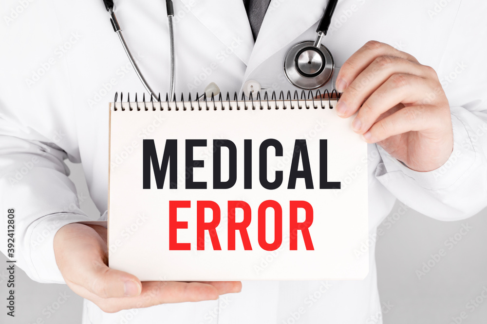 Doctor holding a card with Medical Error, medical concept Doctor holding a card with Medical Error, medical concept