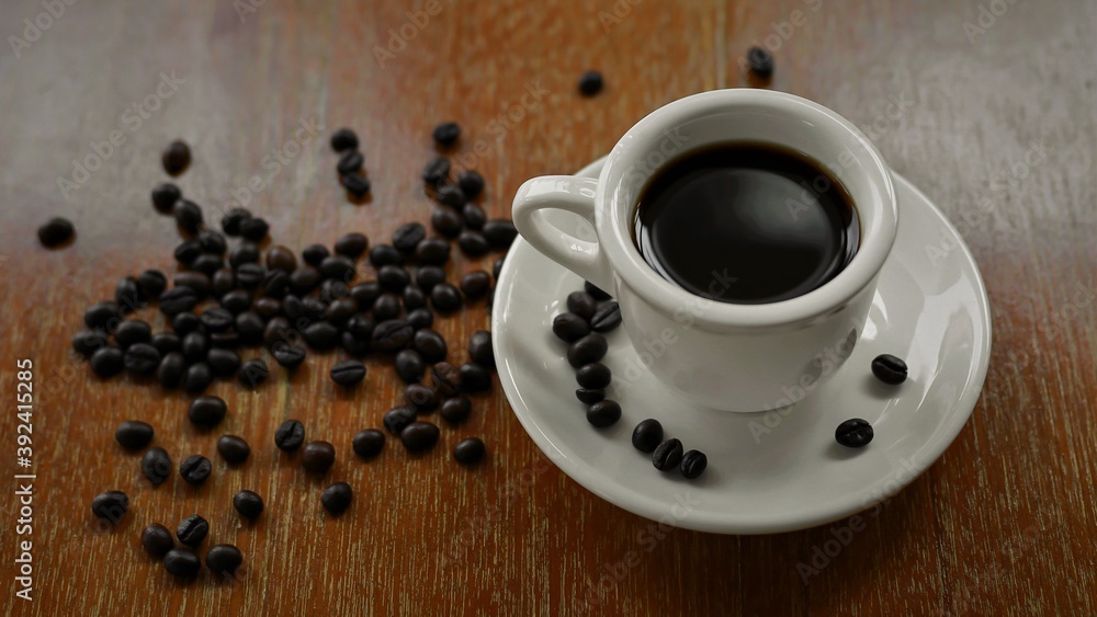 Coffee cup and saucer on a wooden table. Dark background. Coffee cup and saucer on a wooden table. Dark background.