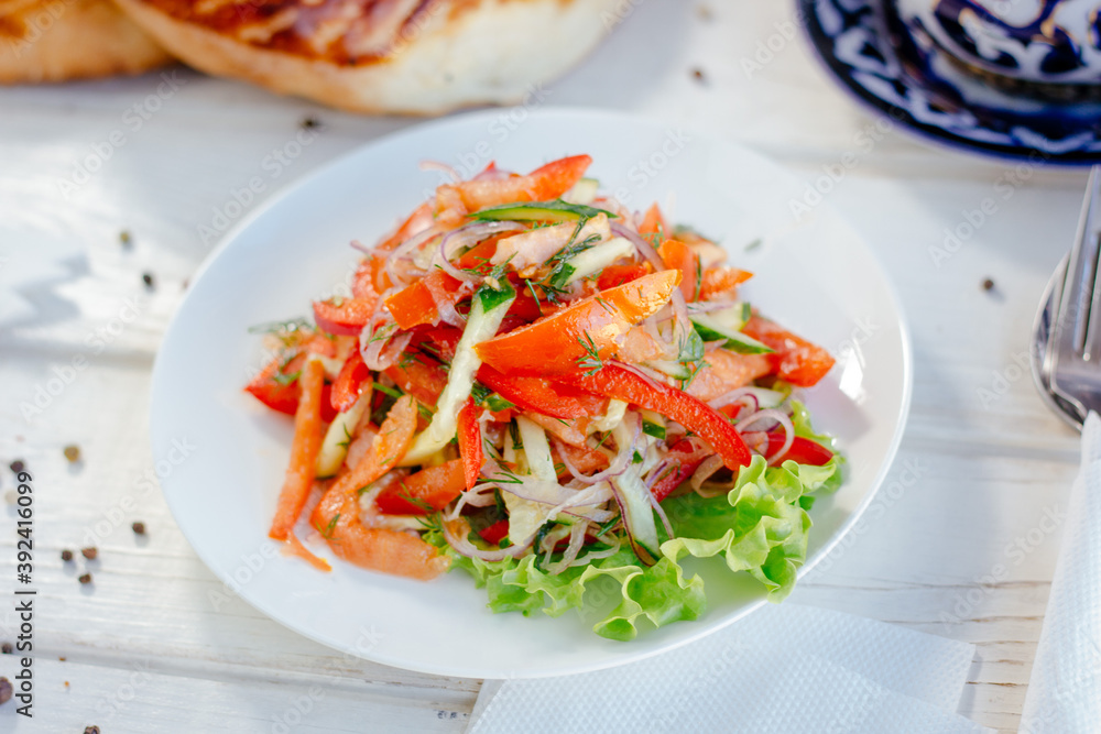 Vegetable salad on the white plate. Achik Chukchuk salad with tomatoes and onion. Vegetable salad on the white plate. Achik Chukchuk salad with tomatoes and onion.