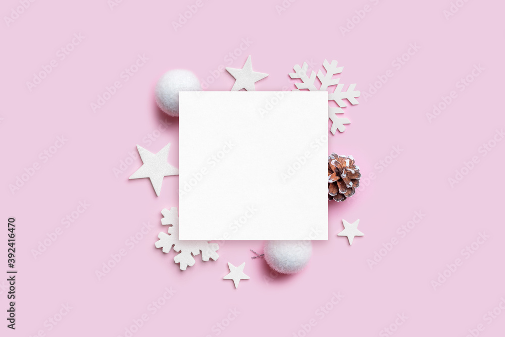 Christmas greeting card mockup with Christmas decorations on pastel pink desk. Blank paper for greeting text. Top view, flat lay Christmas greeting card mockup with Christmas decorations on pastel pink desk. Blank paper for greeting text. Top view, flat lay
