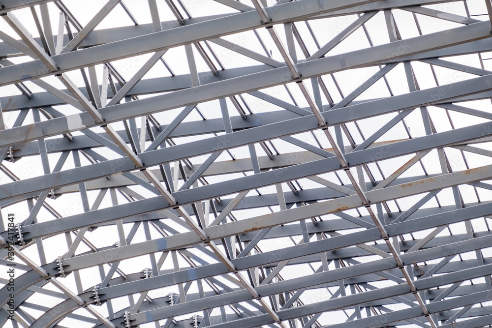 Row of stadium roof metal supports structure. Industrial steel background.