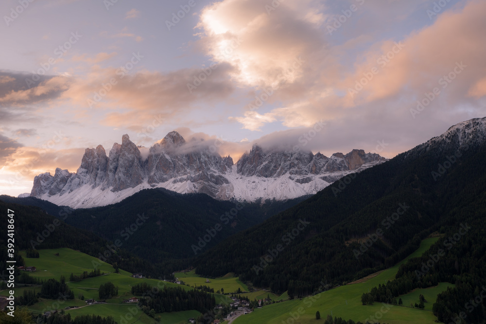 Fototapeta premium Sunrise over the small Italian mountain town of St. Magdalena in Val di Funes