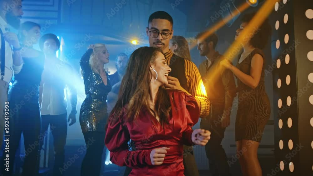 Young couple at the bar dancing together with friends all having a great time Young couple at the bar dancing together with friends all having a great time