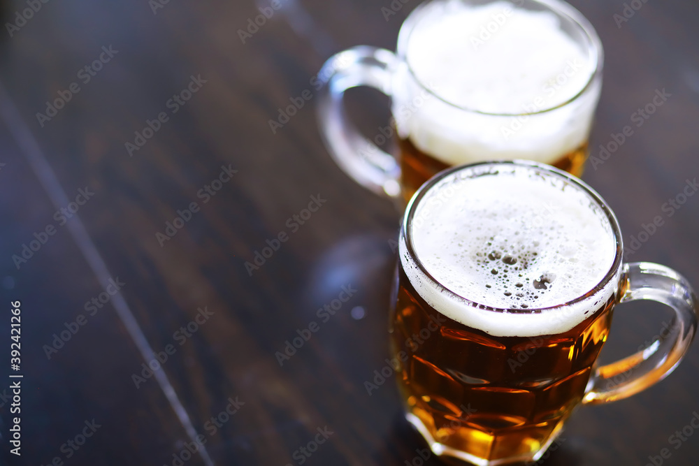 Glass of fresh beer on a wooden table. Lager beer mug on stone table. Top view with copy space Glass of fresh beer on a wooden table. Lager beer mug on stone table. Top view with copy space