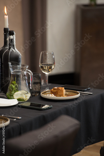 Delicious apple pie charlotte with caramel on the plate on black tablecloth