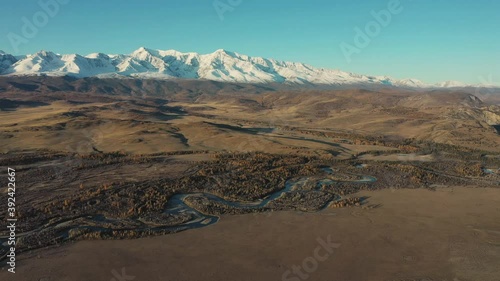 Russia's most popular travel destination, autumn scenery. Altai's spectacular snow-capped mountains reflect, frozen lakes and larch trees.