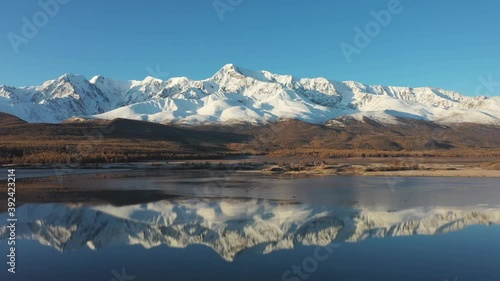 Russia's most popular travel destination, autumn scenery. Altai's spectacular snow-capped mountains reflect, frozen lakes and larch trees.