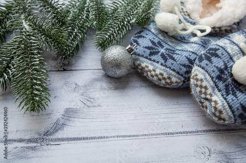 christmas tree decoration and blue Christmas slippers on wooden background 
