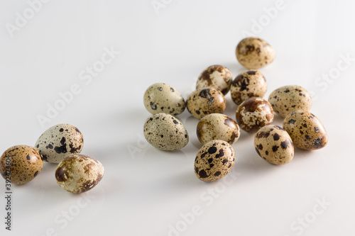 Raw quail eggs on white background