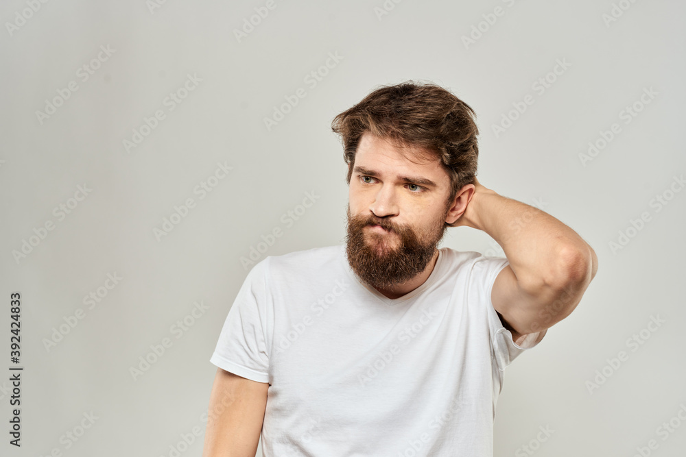 man in white t-shirt gesturing with his hands studio dissatisfaction lifestyle light background man in white t-shirt gesturing with his hands studio dissatisfaction lifestyle light background