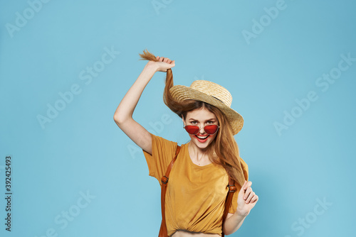 Cheerful pretty woman wearing sunglasses fashion blue summer background