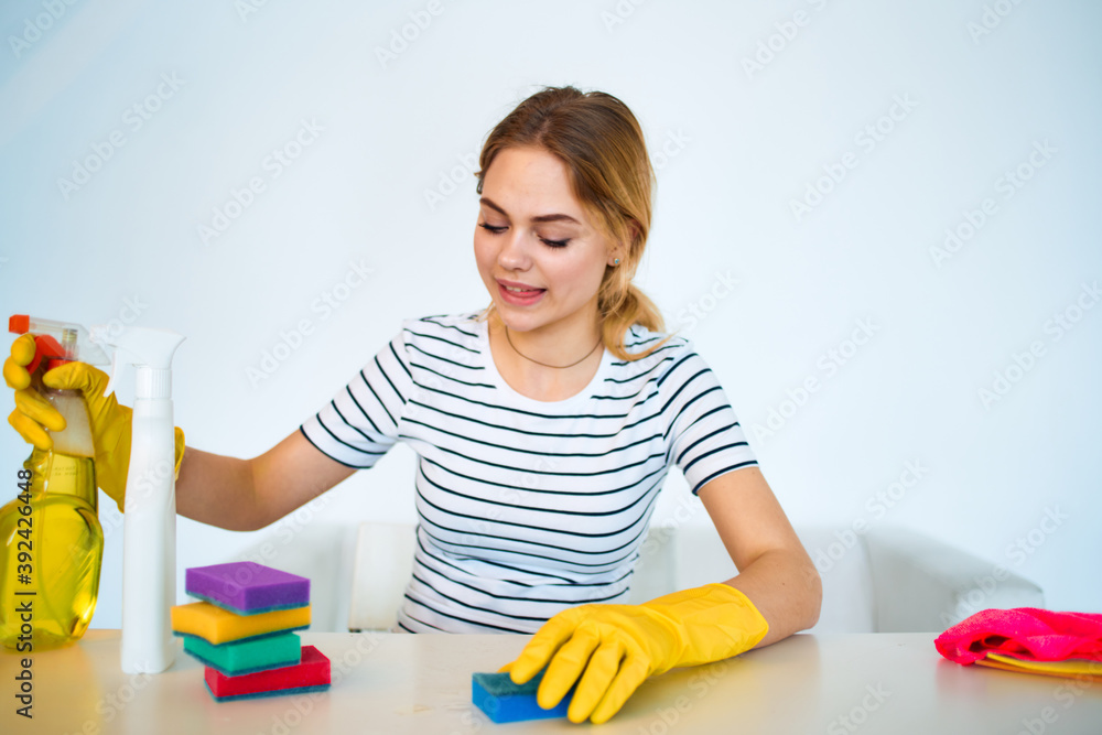 The cleaning lady sits at the table washing supplies cleaning work service The cleaning lady sits at the table washing supplies cleaning work service