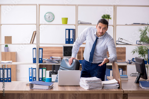 Young male employee unhappy with excessive work