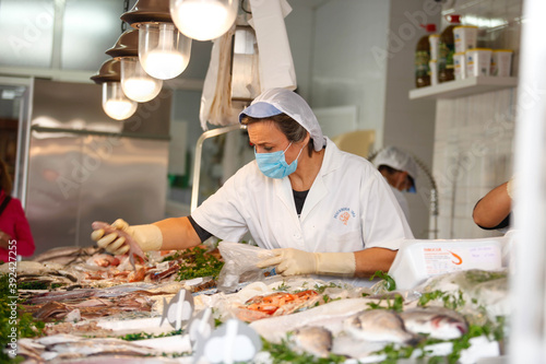 Working portrait of a fishmonger with workers