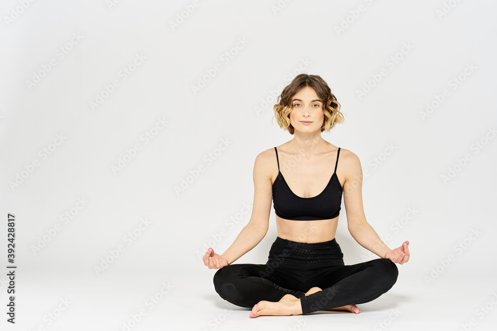Yoga asana woman crossed legs meditation light background room Yoga asana woman crossed legs meditation light background room