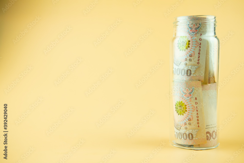 Thai money 1000 Thai Baht banknote in the glass bottle. Concept of saving finance investment Thai money 1000 Thai Baht banknote in the glass bottle. Concept of saving finance investment