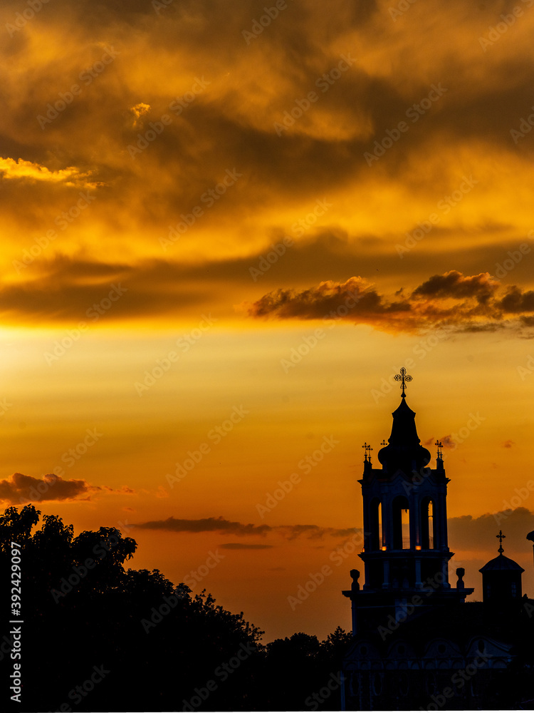 Dramatic sunset with clouds over a church