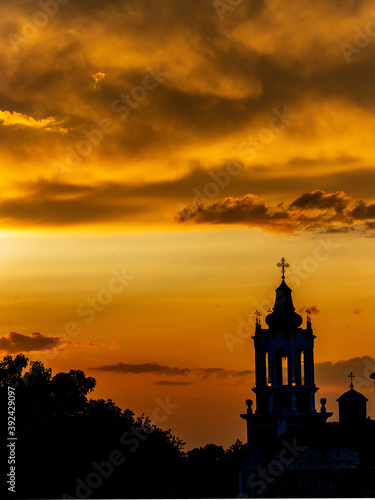 Dramatic sunset with clouds over a church