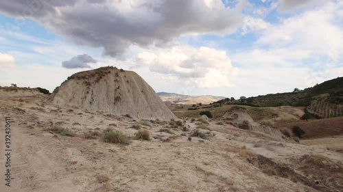 Exploring the desert landscape with the formation of badlands in the National park of Aliano in Basilicata, south Italy photo