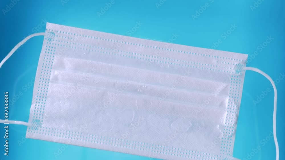 A medical protective mask on the water surface water pollution during the covid-19 crisis with ties slowly drifts on the surface of the water. A medical protective mask on the water surface water pollution during the covid-19 crisis with ties slowly drifts on the surface of the water.