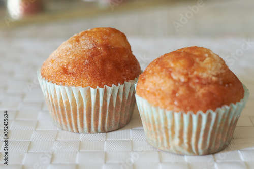 Two muffins on a white tablecloth. Cupcakes close up.
