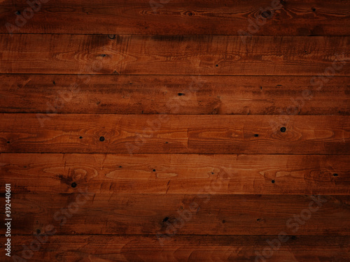 background from boards painted with brown dark orange paint, old vintage, wood texture in knots, boards horizontally