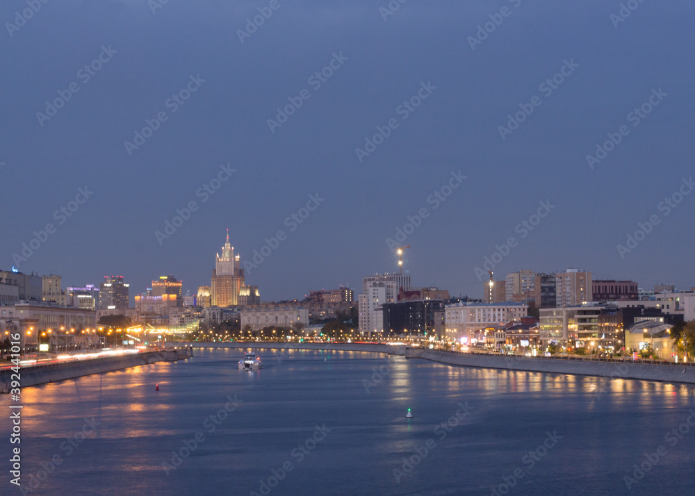 moscow, Russia,Sep 27, 2020: Moscow river in evening. Twilight. Car traces. Skyscraper of Ministry of Foreign Affairs in background