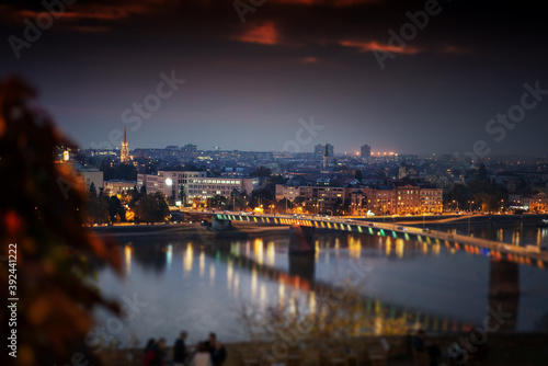 Beautiful city night landscape, view of the Danube city Novi Sad tilt shift effect © olezzo