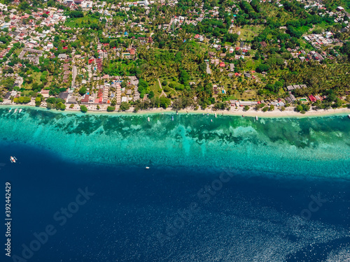 Tropical island with hotels  beach and ocean. Aerial view.