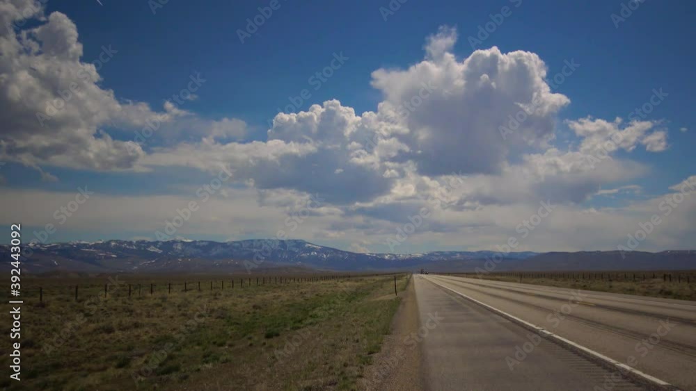Big white clouds over the highway, landscape with big white clouds, USA North Dakota Big white clouds over the highway, landscape with big white clouds, USA North Dakota