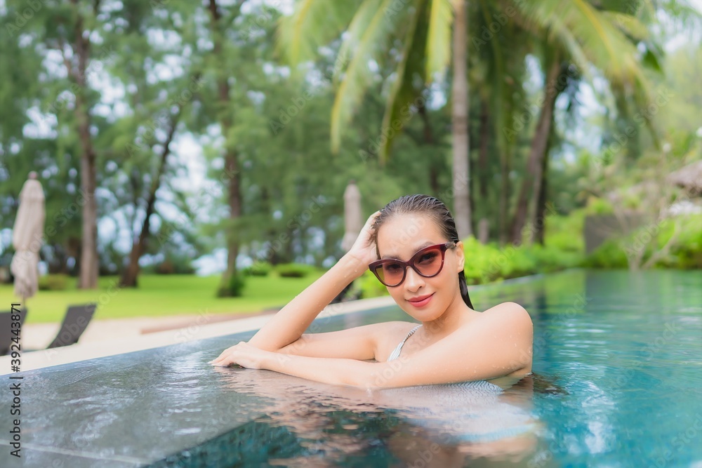 Portrait beautiful young asian woman relax smile leisure around outdoor swimming pool