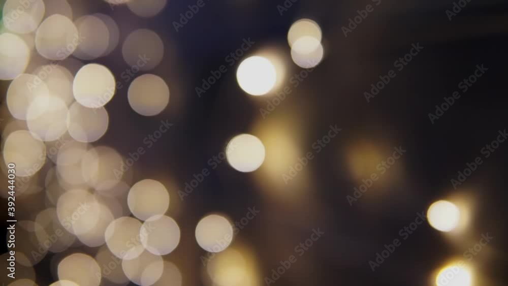 Multicolored bokeh lights twinkle on black background. New year's holiday backdrop. Abstract blurred Christmas festive video. Multicolored bokeh lights twinkle on black background. New year's holiday backdrop. Abstract blurred Christmas festive video.