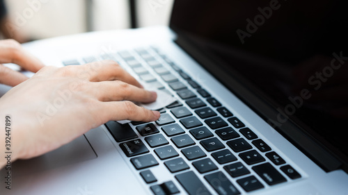 a hand is cleaning laptop keyboard with alcohol swab