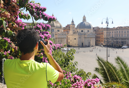 young photographer while taking a picture at Square of People ca
