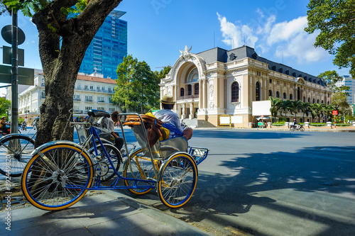 The men and pedicabs were parked in front of the city theater in Ho Chi Minh city, Vietnam.

