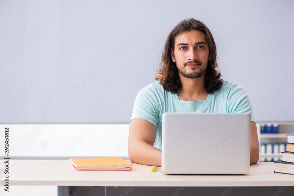 Young male student preparing for exams in tele-education concept Young male student preparing for exams in tele-education concept