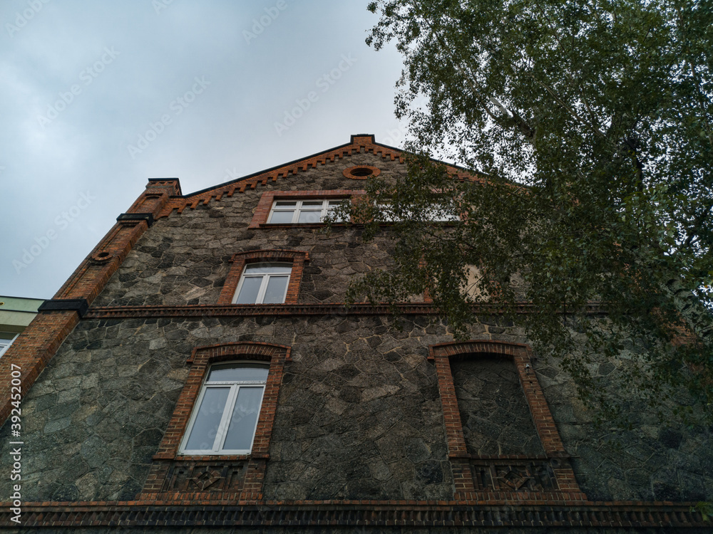 Upward view to old house made by stone and brick with window frame without window Upward view to old house made by stone and brick with window frame without window