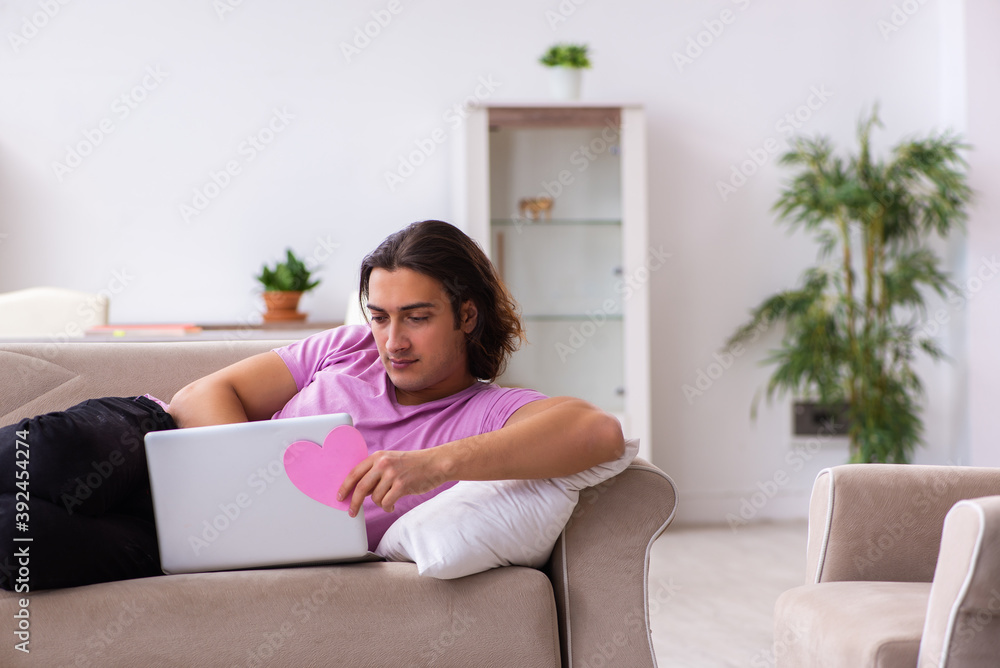 Male student in love preparing for exams at home Male student in love preparing for exams at home