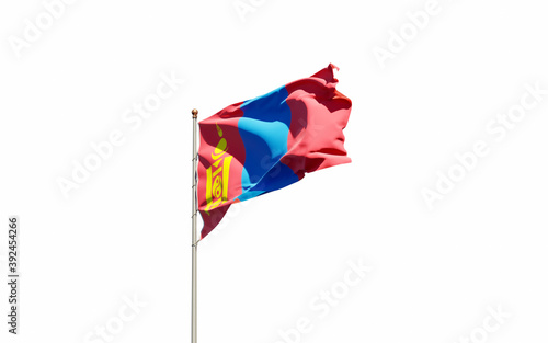 National state flag of Mongolia fluttering at sky background.