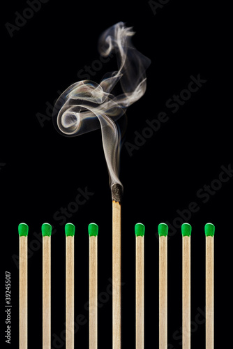 One extinguished match in a group of green matches, emotional burnout, stress, work-life balance