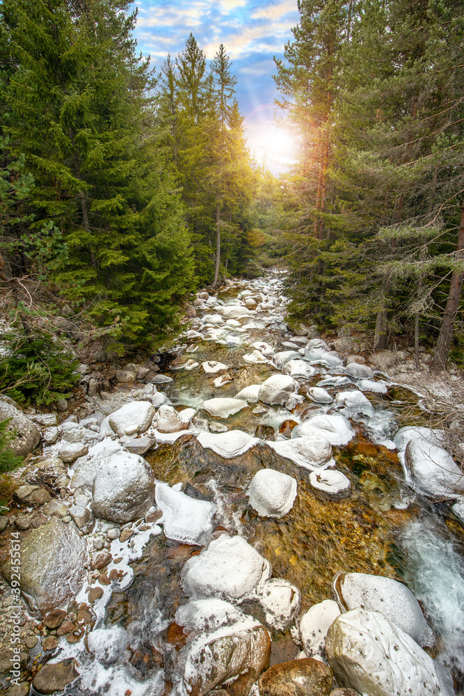 Winter landscape by a river in the sunset. Bansko, Pirin, Bulgaria.