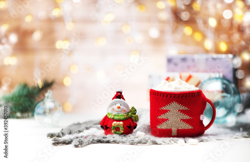 Hot winter drink with marshmallow, snowman, gifts in boxes and Christmas decorations. Christmas or New Year Festive background