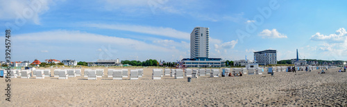 Canvas Print Beach of Warnemuende with hotels and rows of white beach chairs