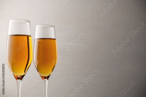 Two glasses of champagne, wine on a gray background, a place for text on the right, copypace. New year and Christmas background
