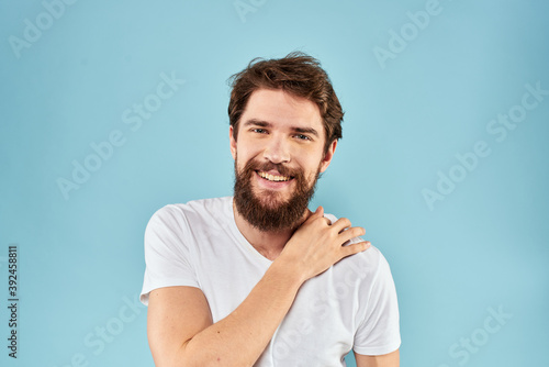 Cheerful man gesturing with his hands emotions cropped view on blue background studio