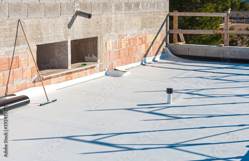 Worker applies pvc membrane roller on roof very carefully. Correct welding with hand-welder, corner.