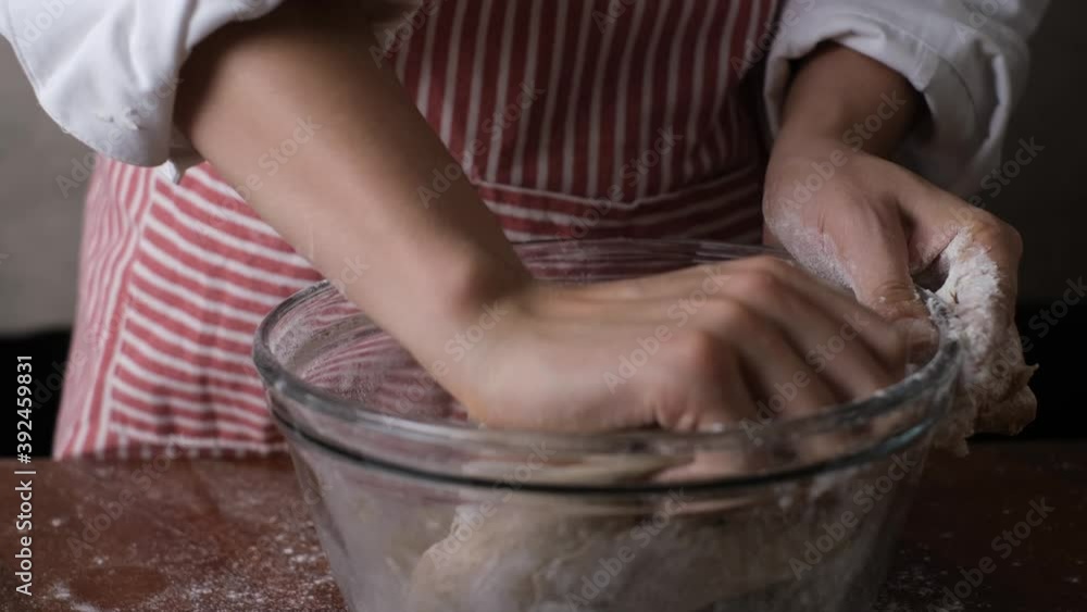 Bakery chef kneeding dough on wooden table. Baking concept. Bakery chef kneeding dough on wooden table. Baking concept.