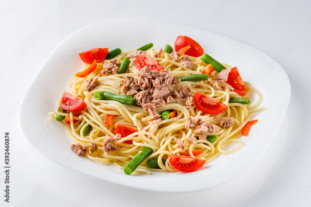 delicious traditional Italian pasta with tuna on a white background delicious traditional Italian pasta with tuna on a white background