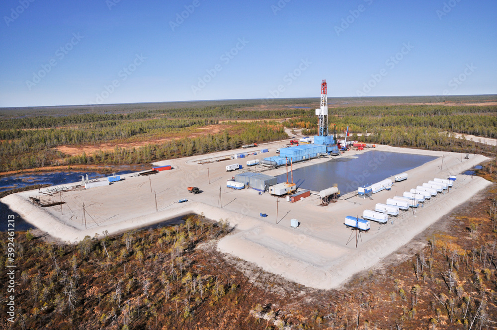 Fototapeta premium Oil rig in swampy and wooded area. There are clean lakes around. Oil production (top view)
