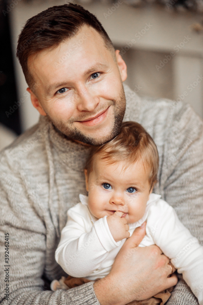 Portrait of handsome father hold little daughter in arms, caring dad spend winter holidays with cute toddler, smiling, enjoy Christmas time at home, fatherhood concept Portrait of handsome father hold little daughter in arms, caring dad spend winter holidays with cute toddler, smiling, enjoy Christmas time at home, fatherhood concept